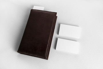 Notepad with blank business cards on grey paper background. Mockup for branding ID.