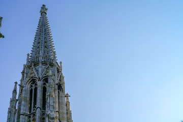 Fototapeta na wymiar Gothic spire against blue sky.