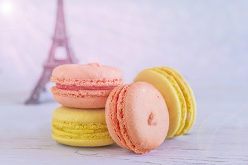French macaroons on white background with eiffel tower with sunshine