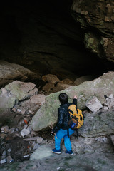 Obraz premium Children explore underground cavern