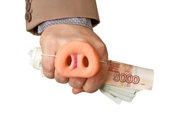 Russian money is clamped in the hand of a businessman with a rubber Piglet put on his hand. 