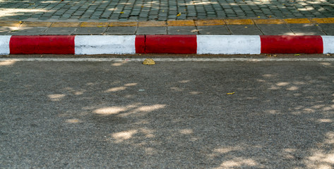 Road with red and white curb