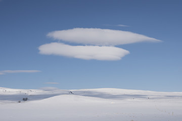 Naklejka na ściany i meble Clouds in winter landscape