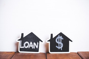 Two small houses over brown wood and white background