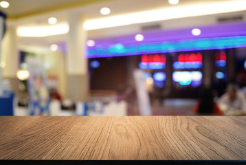 Empty wooden table in front of abstract blurred background of coffee shop . can be used for display or montage your products.Mock up for display of product.
