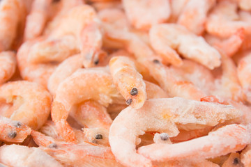 Frozen shrimps in ice. A lot of royal shrimp close-up.