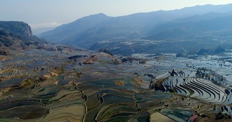View into a valley showing the magnificent Yuanyang Rice Terraces sloping down the mountainsides....