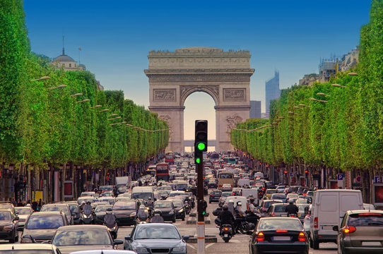 traffic jam with cars in Paris city, France. view of Arc de Triomphe and Champs-Élysées boulevard