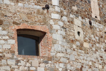 Fototapeta na wymiar Small window in brick wall