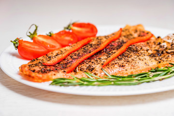 Roasted fish fillet with vegetables close