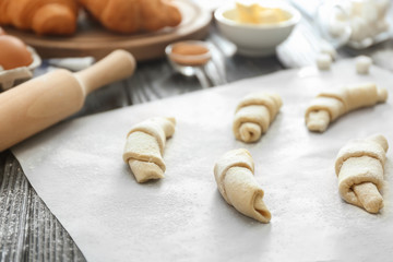 Unbaked croissants on kitchen table