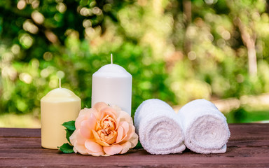 Fresh rose, candles and soft towels. Spa concept. Romantic concept.