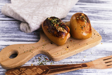 fried pork sausages and spices on a wooden board