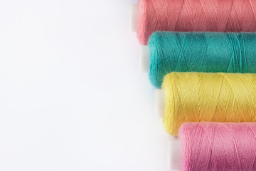 Sewing supplies and accessories for needlework. coils of yellow pink green thread for sewing...