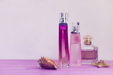 perfume on a pink wooden board