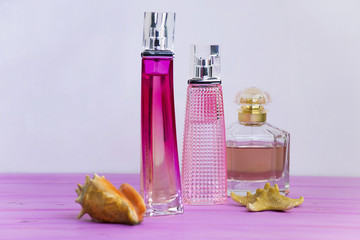 perfume on a pink wooden board