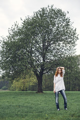 Young adorable woman portrait near tree