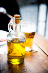 Obraz na płótnie Canvas Olive oil in a glass bottle on a table