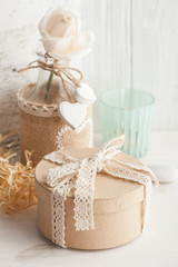 Beautiful tea rose in bottle with lit candle