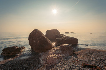 Stones at the seashore in sunrise time.