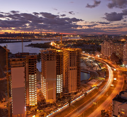 Obraz premium Twilight panoramic cityscape. Aerial view. Modern residential area on left bank of Dnieper river. Kiev. Ukraine