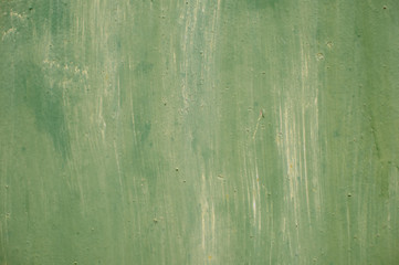 Obraz premium Textured metal surface carelessly colored green paint and faded in the sun in pale gray with rusty specks.