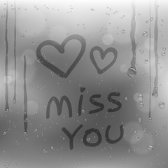 text miss you and hearts on rainy window