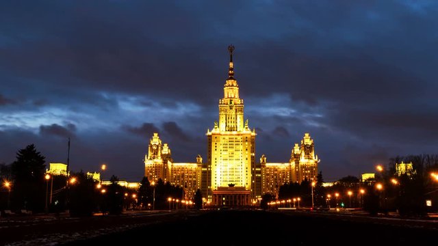 Moscow, Russia. Time-lapse of illuminated Lomonosov Moscow State University at night. Popular landmark in Russia. Time-lapse with car trails and dark fast pacing sunset sky. Pan