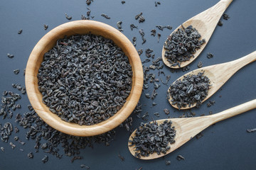 black tea leaves in a wooden bowl