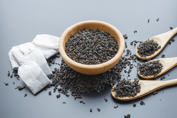 black tea leaves in a wooden bowl
