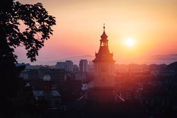 Naklejka premium Town council hall tower morning sunrise scenic view, location Brasov city, Transylvania, Romania. Famous travel destination scenic summer colorful postcard.