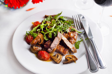 Juicy steak medium rare beef with spices and grilled vegetables.