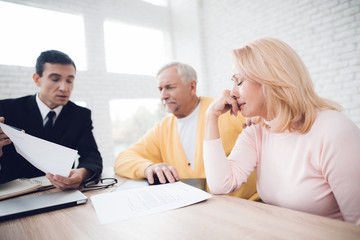 A couple of old people came to see a realtor. The old man and the woman are very upset.