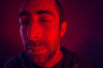Man with peaceful calm facial expression with close eyes