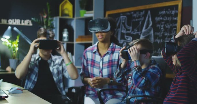 Group of kids and teacher sitting in contemporary laboratory and studying 3d designing and modeling. Movement 4K shot on Red cinema camera.
