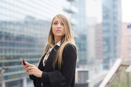 businesswoman talking to mobile in urban environment