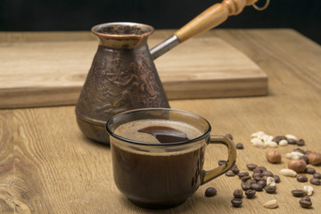 brown mug with coffee and coffee turka, on a wooden table