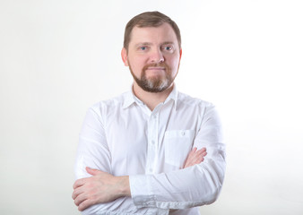 Portrait of bearded man in white shirt.