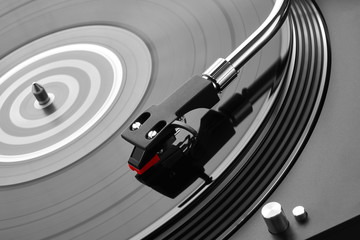 Turntable vinyl record player. Sound technology for DJ to mix & play music. Needle on a vinyl record close-up. Vinyl record player on a background decorations for a party, bright disco lights        