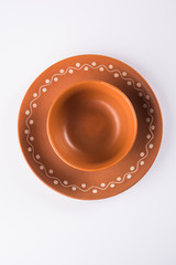 Empty terracotta serving bowl or brown clay soup bowl isolated on white

