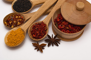 Spice. Spice in a wooden spoon. Herbs. Curry, saffron, turmeric, pepper and other isolated on white background.