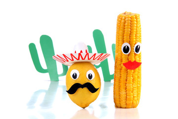 Lemon and corn in the form of Mexican toys on a white background