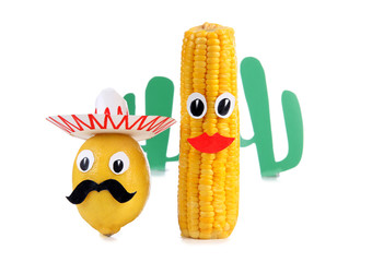 Lemon and corn in the form of Mexican toys on a white background