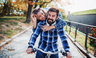 Couple in love. Romantic couple riding a bicycle in the park. Love, dating, romance