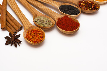 Spice. Spice in a wooden spoon. Herbs. Curry, saffron, turmeric, pepper and other isolated on white background.