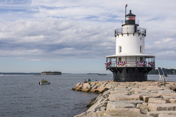 Fototapeta na wymiar Fisherman Works Near Spring Point Lighthouse in Maine