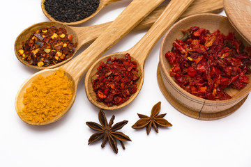 Spice. Spice in a wooden spoon. Herbs. Curry, saffron, turmeric, pepper and other isolated on white background.