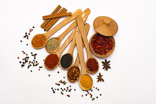 Spice. Spice in a wooden spoon. Herbs. Curry, saffron, turmeric, pepper and other isolated on white background.