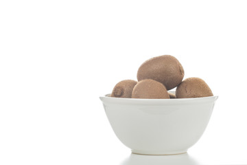 Schüssel mit Kiwis vor weißem Hintergrund
