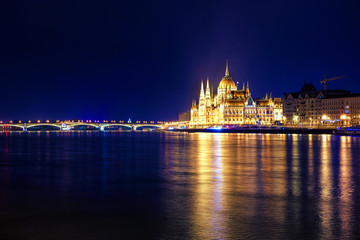 Fototapeta na wymiar Night view of illuminated Budapest with Danube river, parliament, and bridge, Hungary.